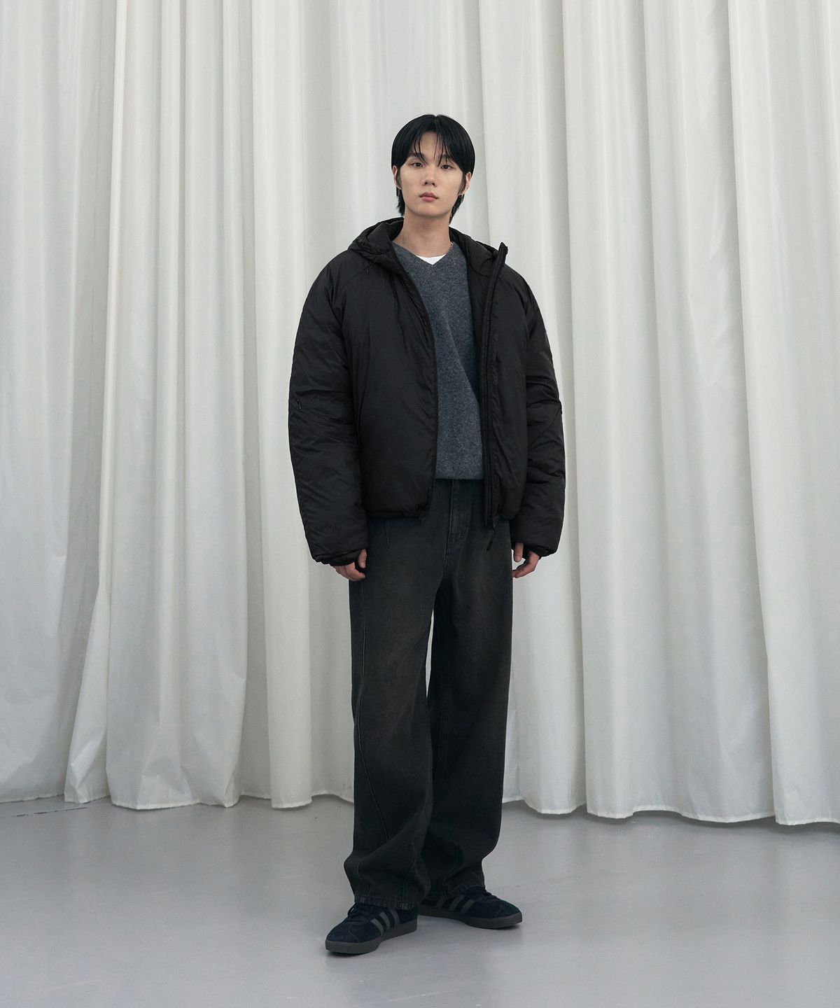 자켓 소매 부분에 생긴 미세한 생활 주름과 약간의 광택감이 보이는 디테일 샷